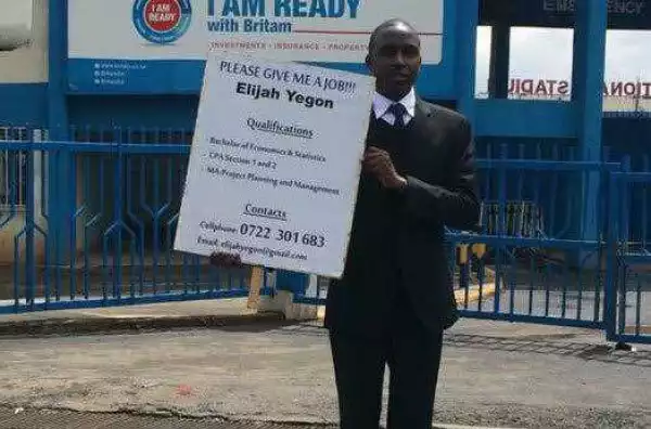Kenyan Master degree holder stands on the road to plead for a job